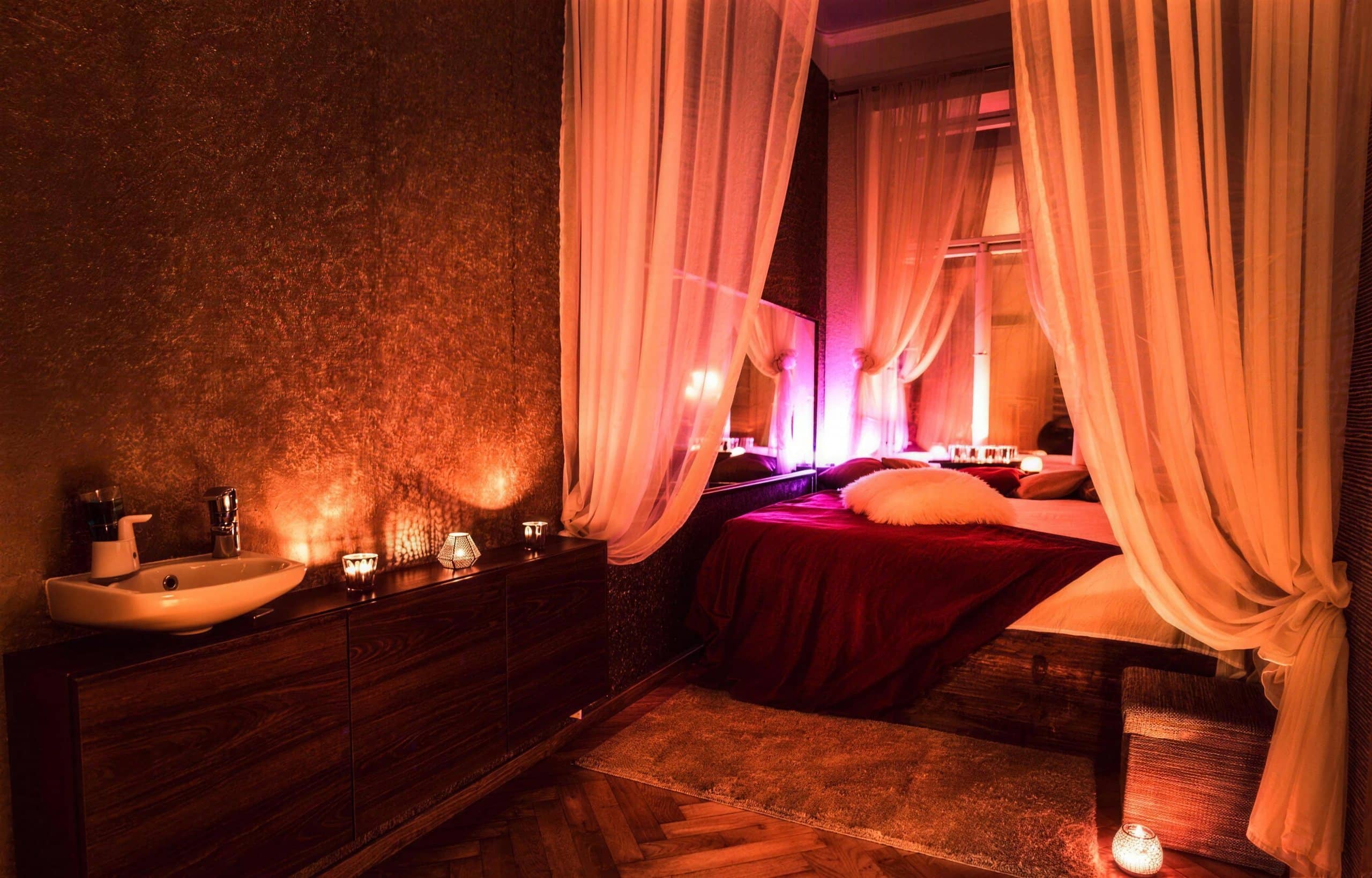 Canopy bed with sheer curtains in a massage room at Imperial salon